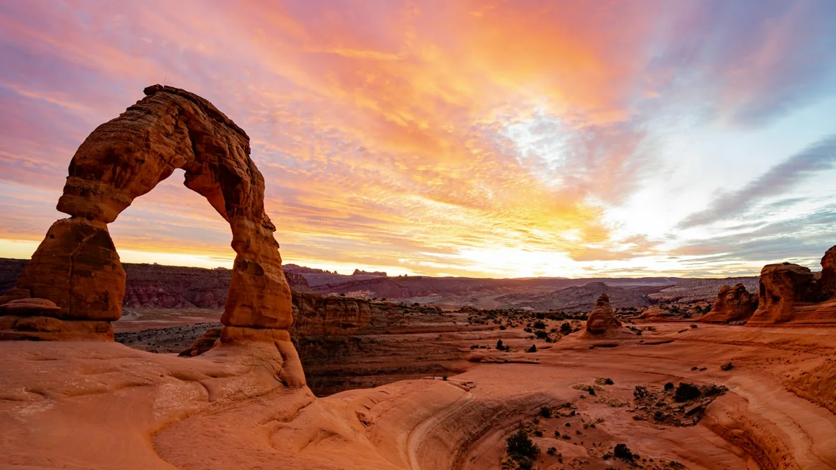 Delicate Arch beneath a colorful sunset near Moab, Utah